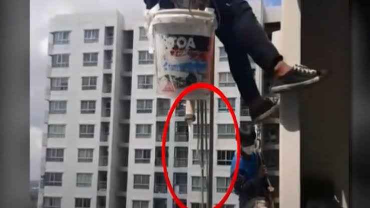 Woman cut rope holding painters 26 floors high