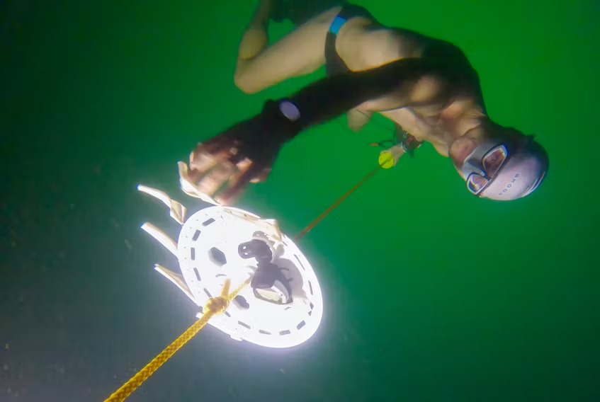 Man dives into icy Swiss lake to set a depth record