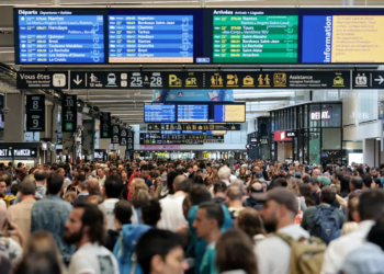 As Paris gears up for the grand opening of the 2024 Olympics today, the city faces a significant disruption due to "malicious acts" targeting the rail network. Here's what you need to know: Massive rail network disruption Paris' rail services have been severely disrupted by what the government described as a "massive attack aimed at paralyzing the network" of France's high-speed trains. This "sabotage" has affected over 800,000 passengers. Targeted sabotage before Olympic opening The coordinated attacks occurred just hours before the Olympic opening ceremony. French Transport Minister Patrice Vergriete announced on X (formerly Twitter) that several TGV lines were targeted, causing severe disruptions expected to last through the weekend. Fires and malicious acts Jean-Pierre Farandou, head of the national rail company SNCF, revealed on BFM TV that fires were set at several rail-line nodes, with individuals fleeing the scenes in vans. SNCF confirmed that arson attacks damaged their facilities, particularly affecting the Atlantic, northern, and eastern lines. SNCF has urged passengers to postpone their trips and avoid train stations. The network will require extensive repairs, cable by cable, to restore normal operations. Eurostar services, especially those connecting Paris to London and Brussels, have also been impacted by the disruptions. Heightened security in Paris The disruptions come amid heightened security measures across Paris. Tens of thousands of police officers, including counter-terrorism units and the military, have been deployed to secure the city. Large sections of Paris have been cordoned off, with Olympic sites, train stations, and tourist landmarks under tight security. Grand opening ceremony details Despite the disruptions, the opening ceremony will proceed as planned. Up to 7,500 competitors will travel down a six-kilometer stretch of the river Seine on a flotilla of 85 boats, marking the start of the 2024 Paris Olympics.