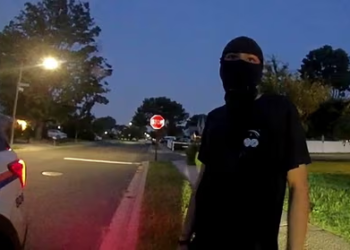 New York suburb makes first arrest under new law banning face masks