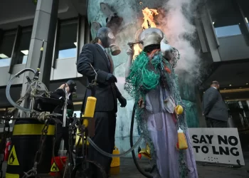 Climate activists ‘drown’ themselves in oil, gas, and flames in shocking protest against LNG in London