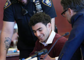 Luigi Mangione smiles in court as he pleads not guilty to murder and terror charges