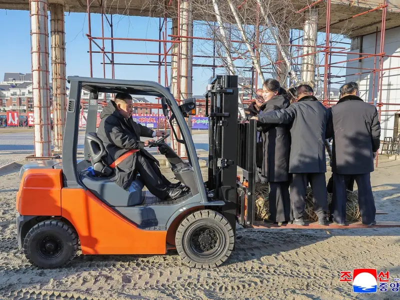 Bizarre Photos Show Kim Jong Un Lifting Daughter, Staff on a Forklift