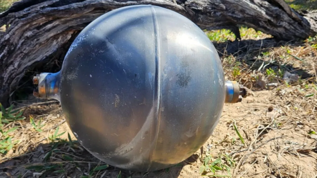 Australian authorities are investigating mysterious silver balls found on a Queensland beach that experts believe could be rocket debris containing hazardous materials.