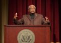 Rep. Jim Clyburn speaking at a lectern at the National Archives