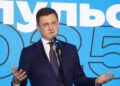 Russian Deputy Prime Minister Alexander Novak speaking into a microphone on stage in Moscow