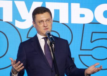 Russian Deputy Prime Minister Alexander Novak speaking into a microphone on stage in Moscow