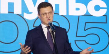 Russian Deputy Prime Minister Alexander Novak speaking into a microphone on stage in Moscow