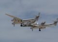 Virgin Galactic's twin-fuselage carrier aircraft Eve flying with an earlier SpaceShipTwo vehicle attached beneath it over Spaceport America