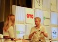 Reddit CEO Steve Huffman, seated on stage, gestures as he speaks during an interview at a Goldman Sachs conference in 2018