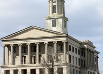 The Tennessee State Capitol in Nashville, a columned limestone building with a central tower, under a cloudy sky