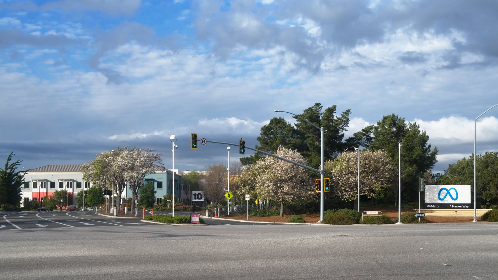 Meta logo sign at the 1 Hacker Way entrance to Meta's headquarters in Menlo Park, California