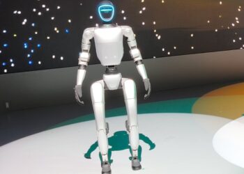 Unitree G1 humanoid robot standing on a lit stage at the Japan Mobility Show 2025 in Tokyo