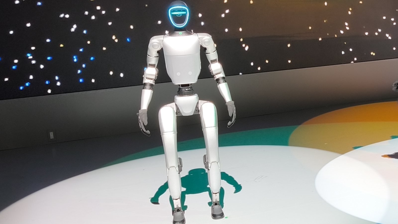 Unitree G1 humanoid robot standing on a lit stage at the Japan Mobility Show 2025 in Tokyo