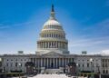 The US Capitol dome and east front seen across the plaza under a blue sky in Washington