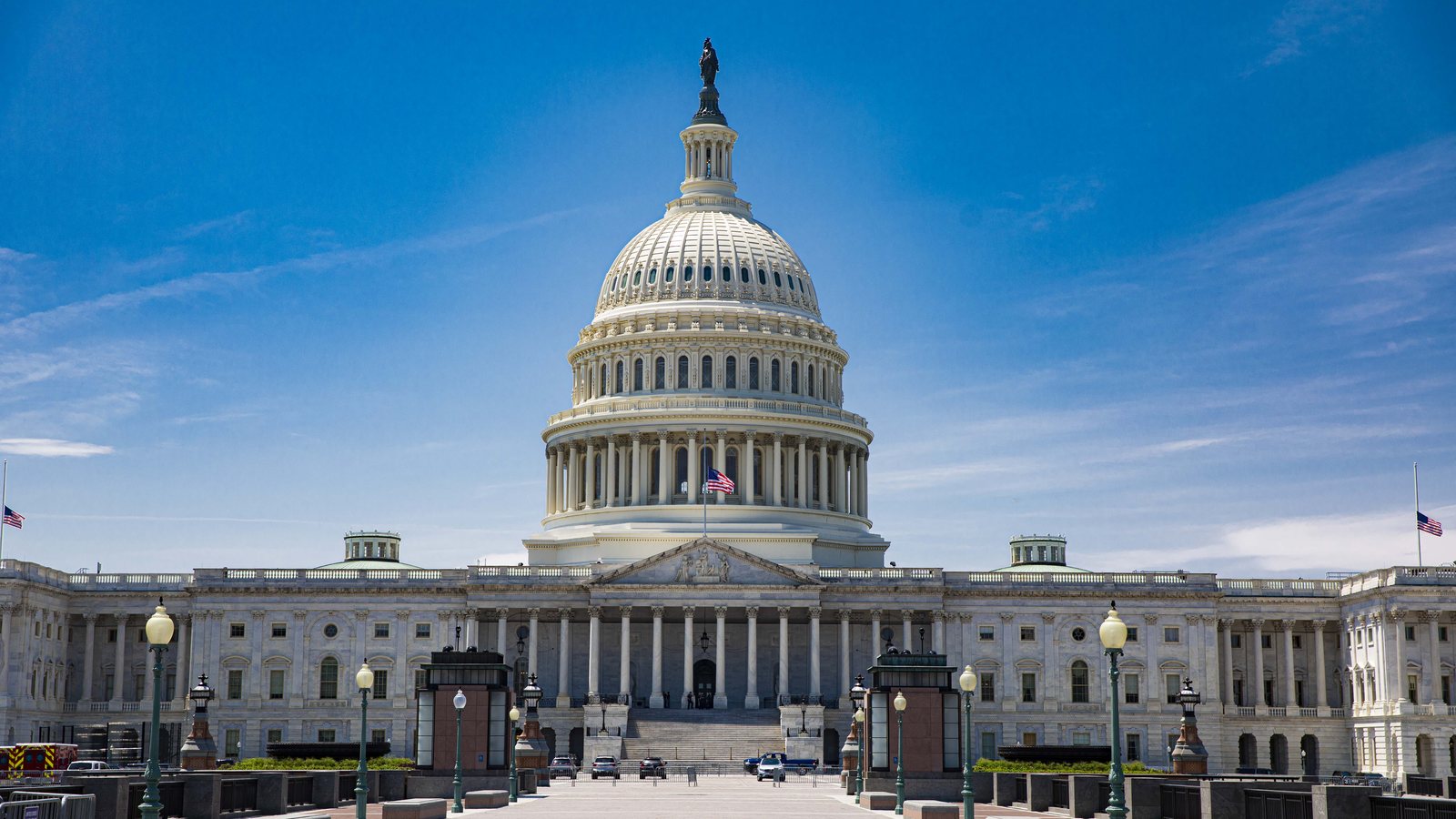 The US Capitol dome and east front seen across the plaza under a blue sky in Washington