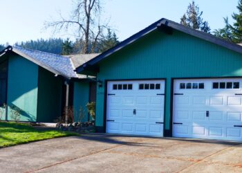 A single-family house with a teal exterior and a two-car garage in Eugene, Oregon