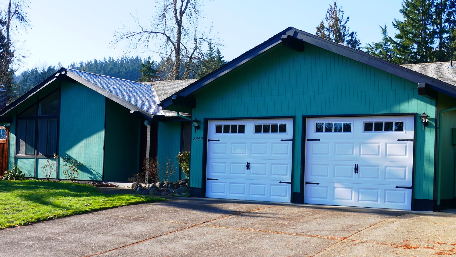 A single-family house with a teal exterior and a two-car garage in Eugene, Oregon