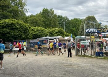 Runners set off on a new hourly loop under an O-SEE Backyard Ultra banner in Zittau, Germany