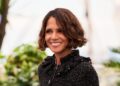 Halle Berry, with short wavy hair and a black tweed jacket, at a daytime photocall in Cannes