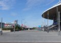 The curved roof and empty forecourt of Stade de France in Saint-Denis, north of Paris, on a sunny day