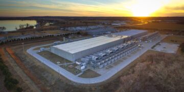 Aerial view of a Google data center building in Council Bluffs, Iowa, at sunset