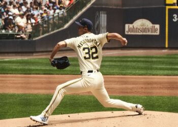 Brewers pitcher Jacob Misiorowski, number 32, in a cream home uniform, striding toward the plate mid-delivery on the mound at American Family Field