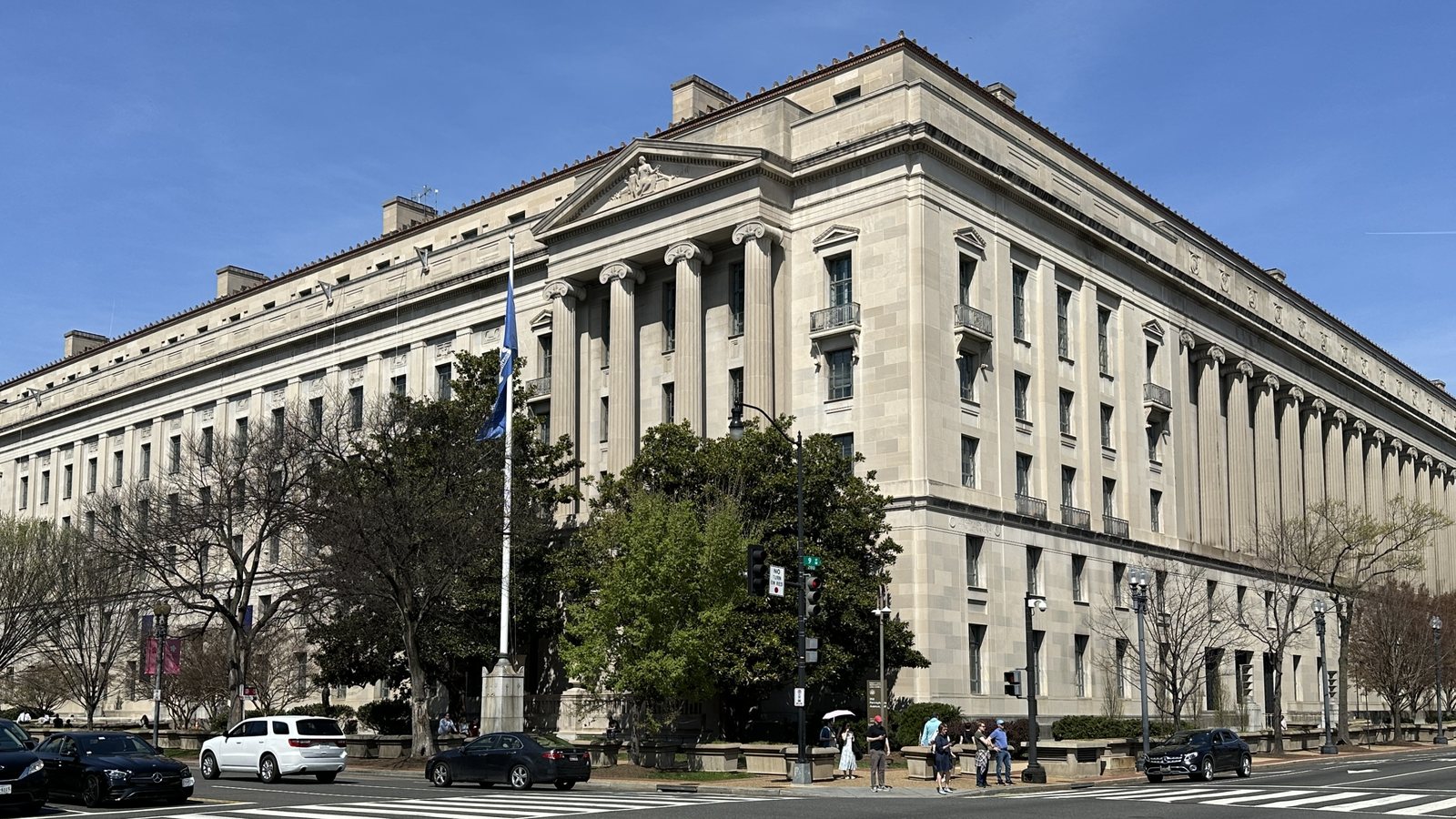The Robert F. Kennedy Department of Justice Building in Washington, D.C., seen from a street corner on a clear day