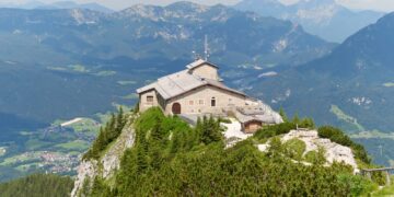 The stone Kehlsteinhaus, or Eagle's Nest, on a forested ridge above Berchtesgaden with Alpine peaks behind