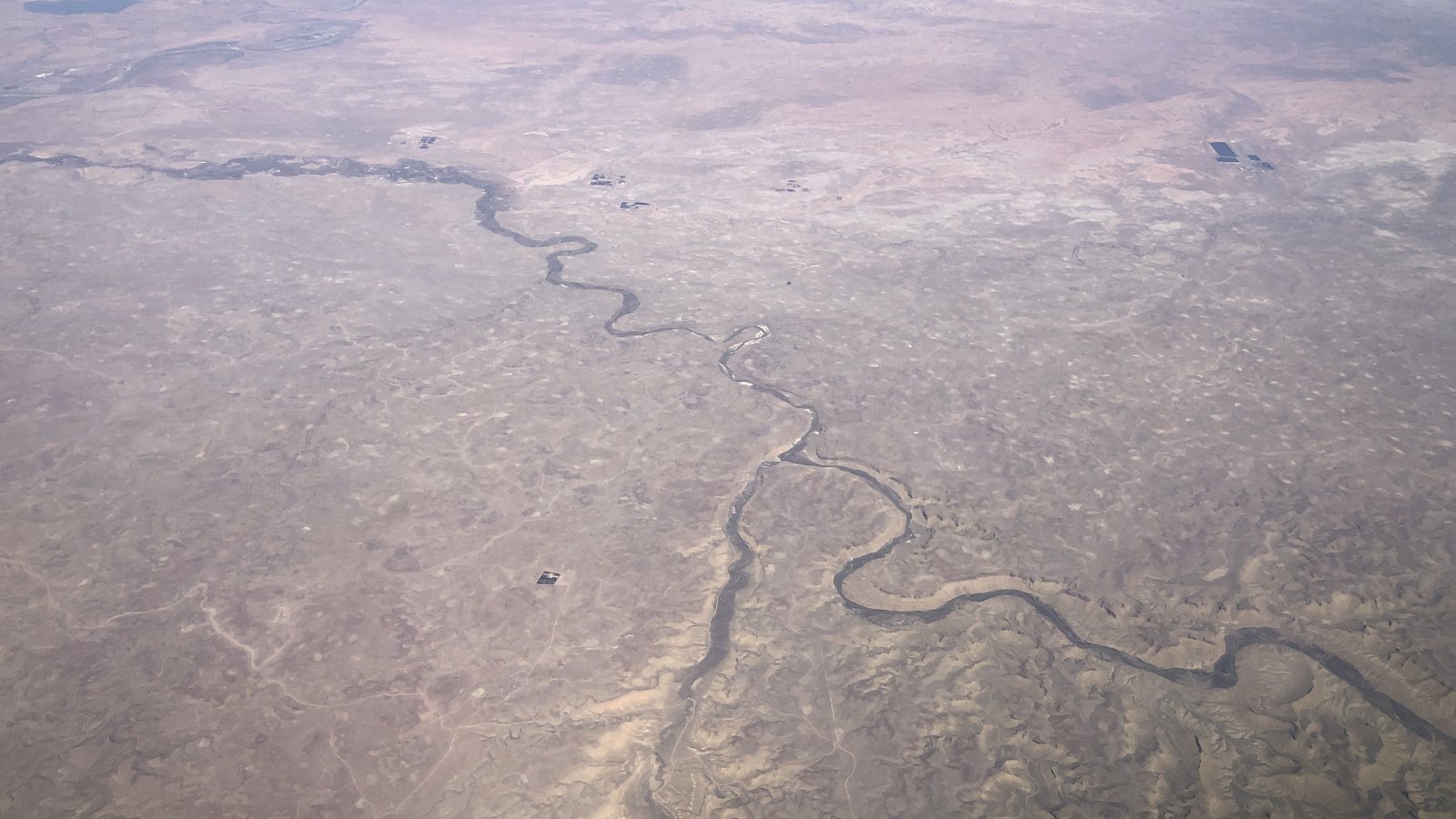 Aerial view of dry rangeland in Uintah County, Utah, with the White River winding across the middle