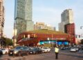Barclays Center, home of the NBA's Brooklyn Nets, seen from a busy Brooklyn intersection with apartment towers behind it