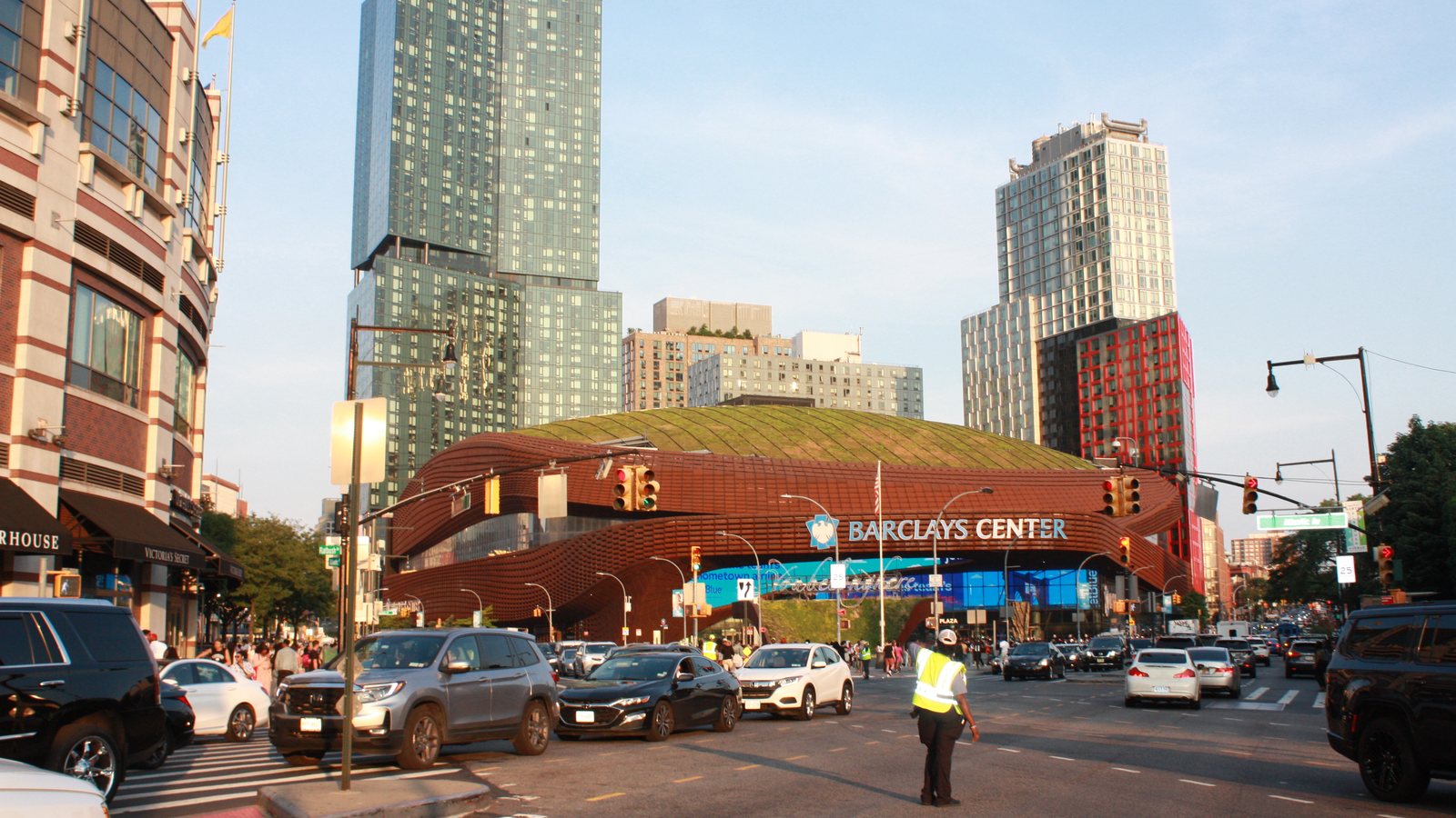 Barclays Center, home of the NBA's Brooklyn Nets, seen from a busy Brooklyn intersection with apartment towers behind it
