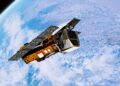 Artist's concept of NASA's Swift Observatory, wrapped in gold foil with solar panels, orbiting above clouds on Earth