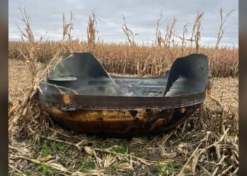 Charred metal dome lying in a harvested cornfield in Stevens County, Minnesota