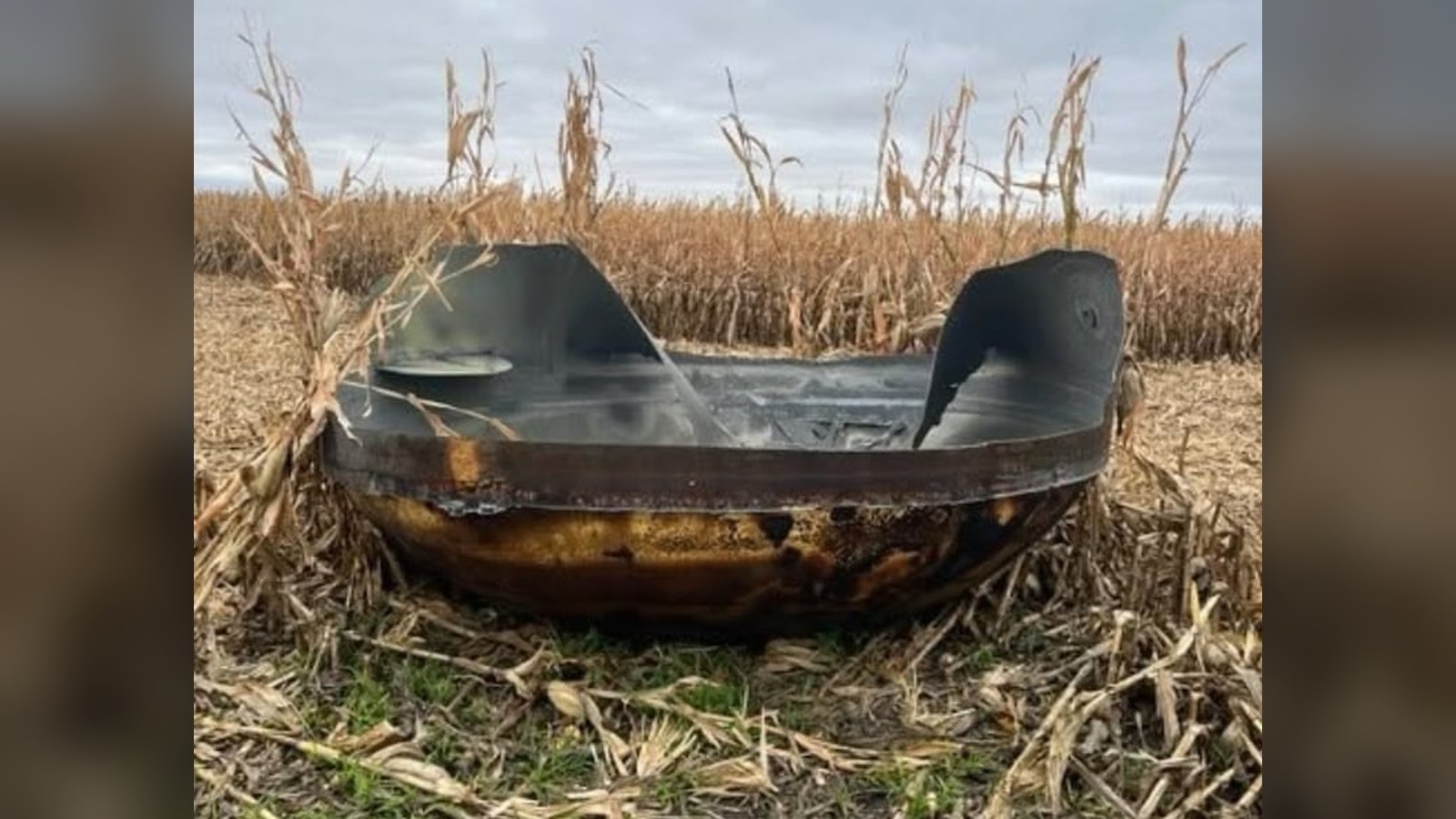 Charred metal dome lying in a harvested cornfield in Stevens County, Minnesota