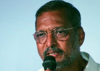 Actor Nana Patekar speaking into a microphone